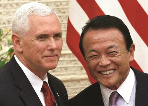 US Vice President Mike Pence (left) and Japanu2019s Deputy Prime Minister Taro Aso attend a joint news conference after their talks at Prime Minister Shinzo Abeu2019s official residence in Tokyo yesterday. Aso said the dialogue turned a u201cnew pageu201d in economic relations between the countries, adding that he had a good discussion with Pence based on a u201cwin-winu201d outlook.