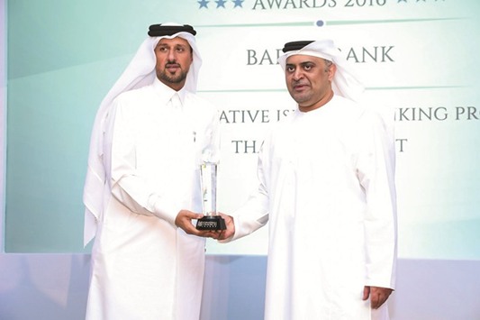 Al-Khaja (left) receiving the award on behalf of Barwa Bank at an event held in Dubai recently.