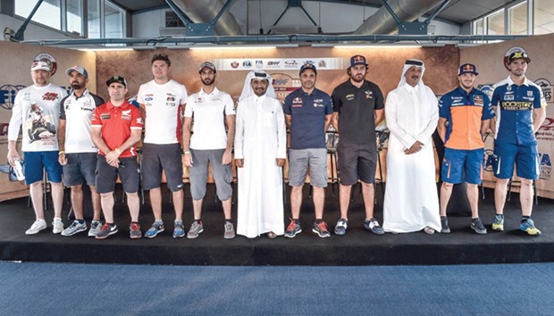 Participants in the Qatar Cross-Country Rally pose with QMMF officials prior to the start of the event.