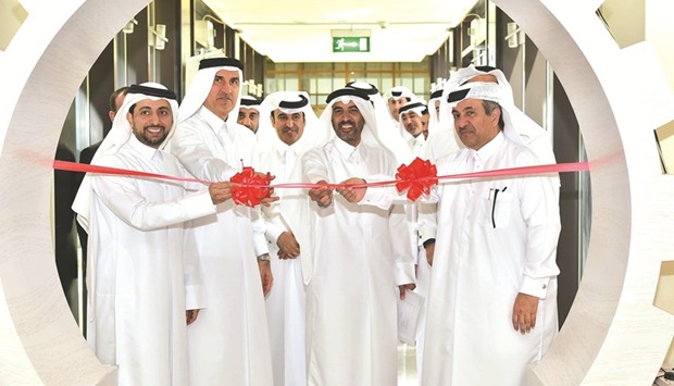 QU and Qapco officials cutting a ribbon to inaugurate the event.