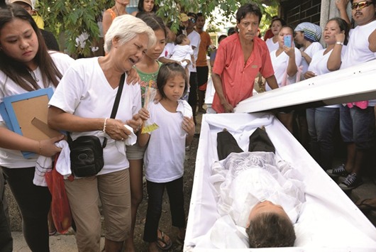 File photo shows the grandmother of five-year-old Francisco Manosca, son of Domingo Manosca, who according to relatives was a drug user, mourns over his body during his funeral in Pasay city, Metro Manila, on December 21, 2016. Unidentified gunmen killed both the father and child.