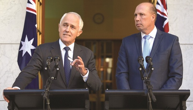 Australiau2019s Prime Minister Malcolm Turnbull speaks as Immigration Minister Peter Dutton listens on during a media conference at Parliament House in Canberra, Australia.
