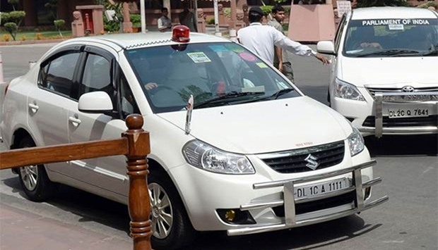 A car with a red beacon stands outside Parliament House in New Delhi.