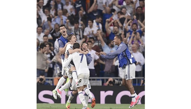 Real Madridu2019s Portuguese forward Cristiano Ronaldo celebrates with teammates during their UEFA Champions League quarter-final second leg football match on Tuesday.