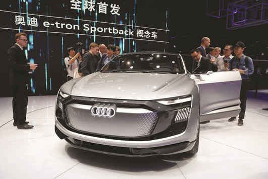 People gather around the Audi e-tron Sportback concept car at the Shanghai Auto Show during its media day yesterday.