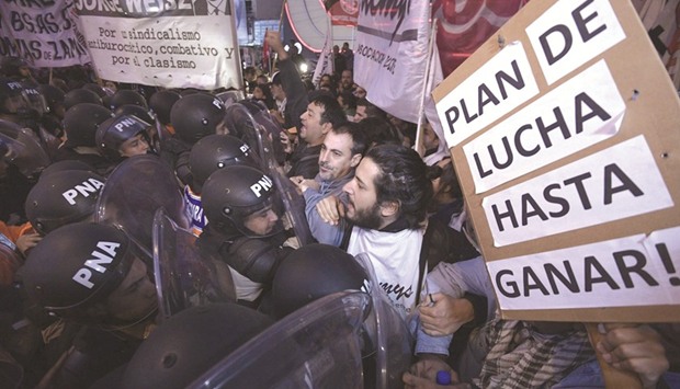 Teachers clash with members of Prefectura Naval Argentina who guard the entrance of Pueyrred?n bridge in Avellaneda, Buenos Aires, during a 24-hour general strike on April 6.