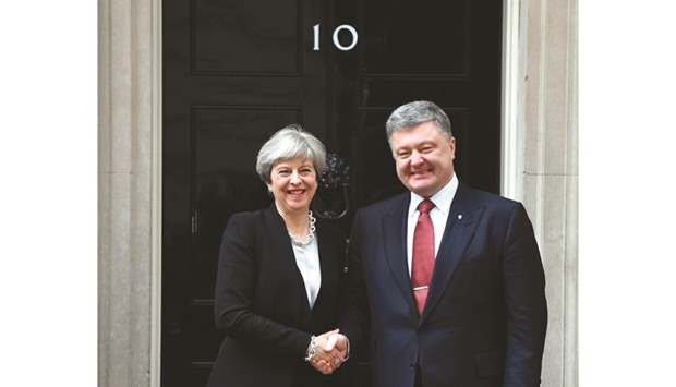 Prime Minister Theresa May greets Ukraineu2019s President Petro Poroshenko at 10 Downing Street in central London yesterday as he arrives for talks. May met Poroshenko after attending the parliamentary vote that confirmed her call for an early general election.
