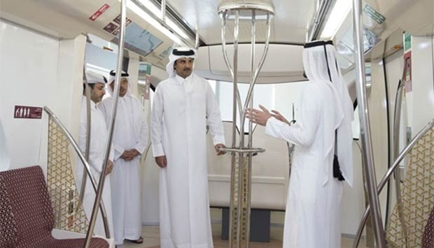 HH the Emir inspects the cabin of a prototype train during a visit to the Doha Metro Rail project in West Bay on Thursday.