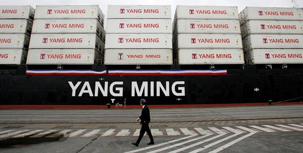 A man walks past a cargo ship bound for China during a ceremony at a port in the northern Taiwan city of Keelung. Taiwanu2019s export orders in March rose 12.3% from a year earlier, above the 10% forecast in a Reuters poll but slowing from a 22% pace the prior month.