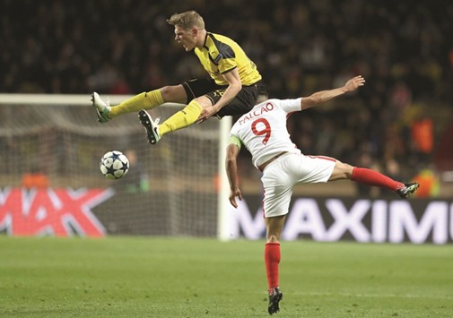 Dortmundu2019s defender Matthias Ginter (L) and Monacou2019s Colombian forward Radamel Falcao collide during theIR UEFA Champions League match on Wednesday.