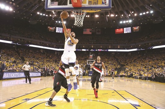 Stephen Curry (foreground) of the Golden State Warriors goes up for a shot in second game of the Western Conference quarter-finals against Portland Trail Blazers in Oakland, California, on Wednesday. (AFP)
