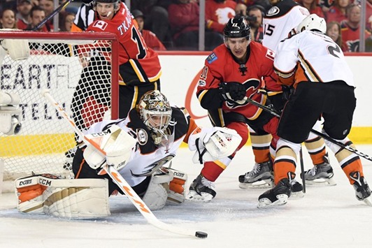 Anaheim Ducks goalie John Gibson (left) stops a shot from the Calgary Flames in game four of the first round of the 2017 Stanley Cup Playoffs in Calgary, Canada, on Wednesday. (USA TODAY Sports)