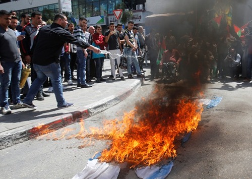 Palestinian demonstrators burn an Israeli flag during a rally in support of Palestinian prisoners on hunger strike in Israeli jails, in the West Bank city of Nablus.
