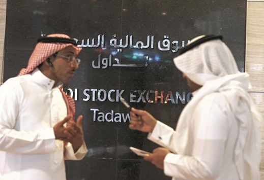 Traders talk at the Saudi Stock Exchange (Tadawul) in Riyadh. The Saudi index was the worst performer in the Gulf for the week, down 2.5%.