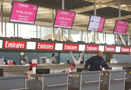 The ticketing and check-in counters for Emirates airlines appear quiet inside the terminal on March 21 at John F Kennedy International Airport in New York. Emirates will pare service to five US cities after the country banned on-board electronics on flights from some Middle Eastern airports and attempted to block travel from six predominantly Muslim nations.