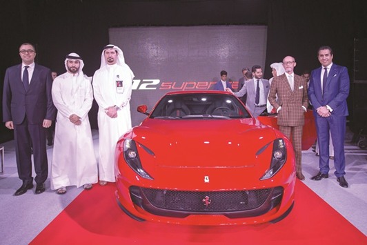 Officials with the new  Ferrari 812 Superfast at the  five-day Qatar Motor Show 2017 taking place at the Qatar  Exhibition and Convention centre.