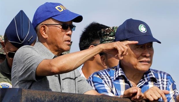 Philippine Defence Secretary Delfin Lorenzana (left) and other government and military officials inspect Philippine-occupied Thitu Island in Spratly Islands in the disputed South China Sea on Friday.