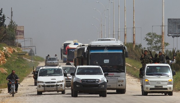 A convoy of buses carrying Sunni rebels and civilians, who were evacuated from Zabadani and Madaya, as part of a reciprocal evacuation deal for four besieged towns, travels towards rebel-held Idlib.