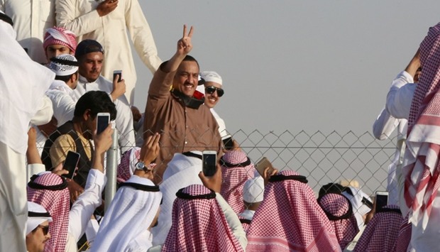 Supporters of Kuwaiti opposition leader Mussallam al-Barrak (C) celebrate his release from jail on April 21, 2017 in Kuwait City.