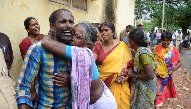 Indian relatives comfort each other as they gather at a hospital in Yerpedu near Tirupati on April 21, 2017, where injured patients were admitted after a lorry crashed into a crowded market area in the southern Indian state of Andhra Pradesh.