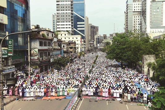 Activists from an Islamist group offer Friday prayers prior to participating in a protest in Dhaka yesterday, which calls for the removal of a statue in front of the Supreme Court.