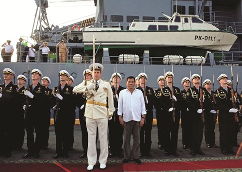 President Rodrigo Duterte stands to attention after touring Russian Navy guided missile cruiser Varyag, docked during a goodwill visit, at Pier 15, South Harbour, Metro Manila, yesterday.