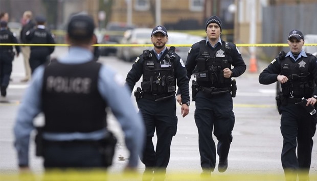 Chicago Police officers walk near the scene