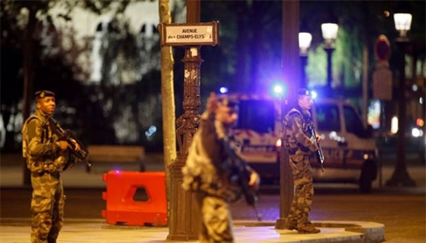 Armed soldiers secure the Champs Elysees avenue after a policeman was killed and two others were wounded in a shooting incident in Paris on Thursday.
