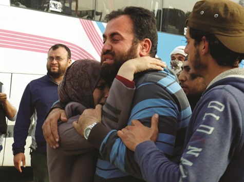 Newly released prisoners, who were held by Syrian government, are welcomed upon their arrival at Al-Rashidin, Aleppo province, yesterday.