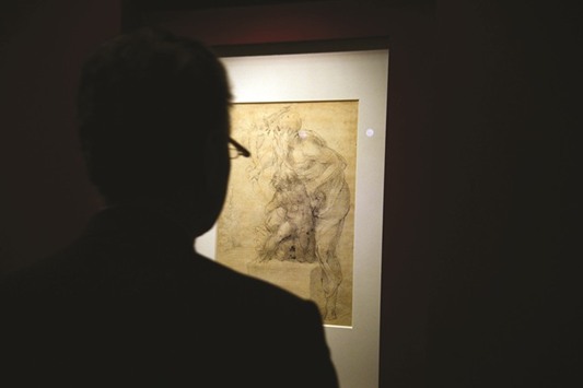 A visitor looks at Michelangelou2019s drawing on paper in black pencil, red pencil and pen of The Sacrifice of Isaac in Romeu2019s Capitolini Museums.