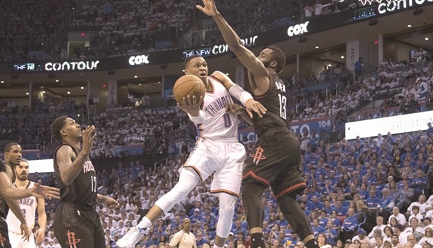 Russell Westbrook (No 0) of the Oklahoma City Thunder drives around James Harden (No 13) of the Houston Rockets for two points during the second half of game three in the NBA Playoffs Western Conference quarter-finals in Oklahoma City, Oklahoma. (Getty Images/AFP)