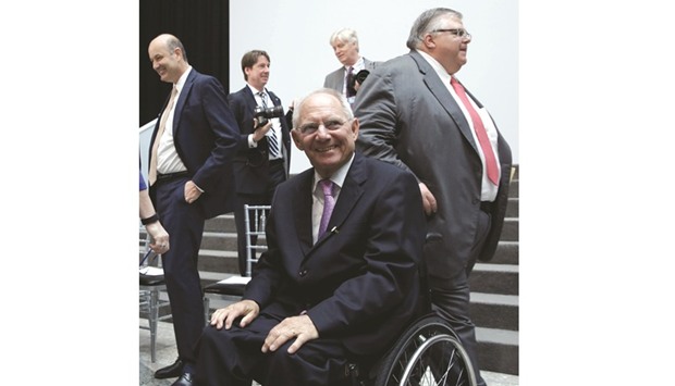 German Finance Minister Wolfgang Schaeuble smiles after a G-20 family photo during the IMF-World Bank spring meetings in Washington. u201cWe need to make our economies more robust against potential future crises,u201d he said at a G-20 press briefing on Friday.