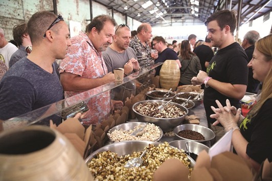 Customers looking at different insects for sale at a stall in Sydney.
