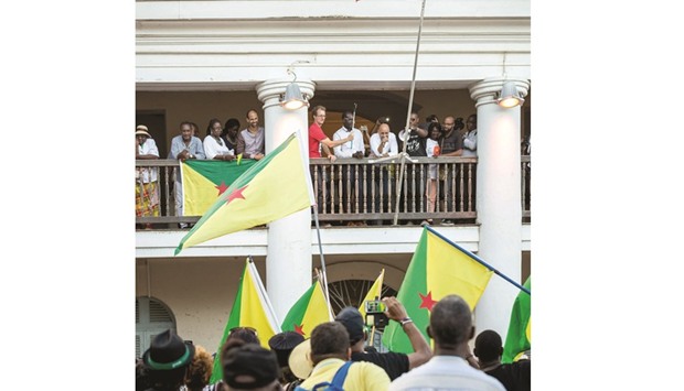 Representatives of the collective announce to a cheering crowd the signing of an agreement with the government at the Prefecturate in Cayenne. The agreement ends almost four weeks of strikes and demonstrations.