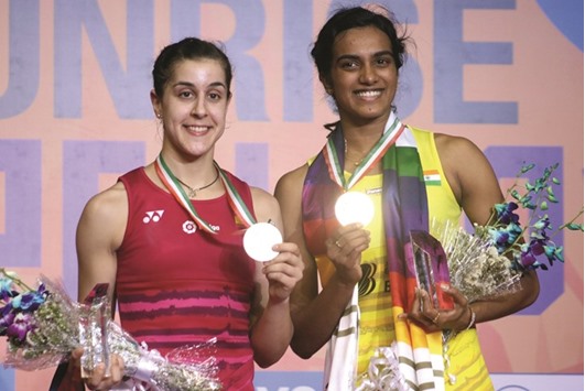 Sindhu with her Spanish counterpart Carolina Marin during the presentation ceremony of India Open Superseries badminton tournament yesterday.