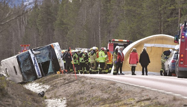 Emergency services personnel are seen at the site of the bus accident on the E45, between Sveg and Fagelsjo, in Sweden.