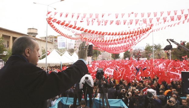A handout photo taken and released on Saturday by the Turkish Presidential Press Service shows Erdogan greeting supporters after delivering a speech during a rally in Diyarbakir, ahead of a referendum on April 16.