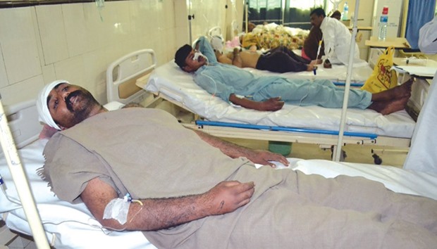 Injured Pakistani men rest in hospital after an attack on a Sufi shrine by three suspects including the shrineu2019s custodian killed at least 20 people on the outskirts of Sargodha District in Punjab province yesterday.