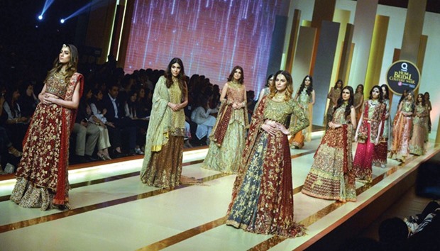 Models present the creation by designer Uzma Babar on the second day of Fashion Bridal Couture Week in Karachi on April 1.