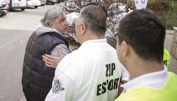 Romaniau2019s head coach Ilie Nastase is escorted by stewards outside the arena where the FedCup Group II play-off match between Romania and Great Britain.