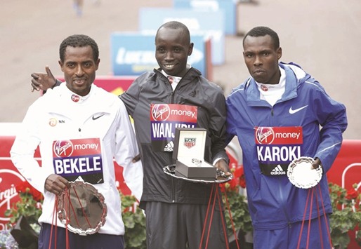 (L-R) Second placed Ethiopiau2019s Kenenisa Bekele, winner Kenyau2019s Daniel Wanjiru and third placed Kenyau2019s Bedan Karoki pose on the podium after the menu2019s elite race at the London Marathon yesterday in London. (AFP)