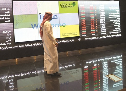 A Saudi investor monitors share prices at the Saudi Stock Exchange, or Tadawul (file). Amwal, the Doha-based asset manager, is buying Saudi stocks in anticipation of the marketu2019s inclusion in emerging-market benchmarks.