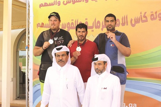 Gold winner Hamad Ahmed al-Kendi (centre), Angelo Roberto Scalzone (left) and bronze winner Mohamed al-Rumaihi on the podium for trap at the Emir Cup Shooting Championship.
