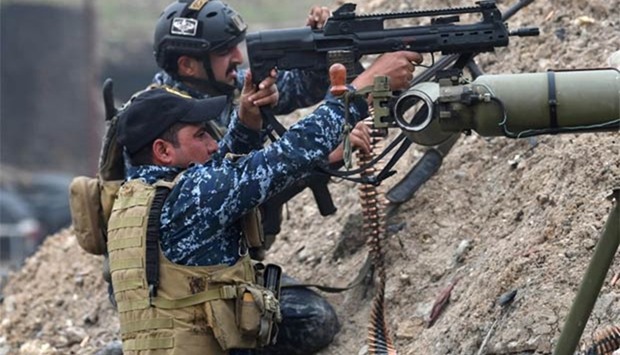 Iraqi federal police fire towards positions held by the Islamic State in west Mosul on Sunday.