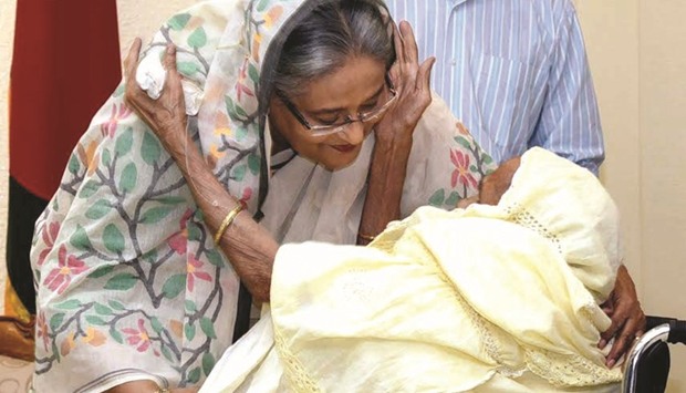 Prime Minister Sheikh Hasina meeting a relative of a 1971 war hero on a wheelchair in Dhaka yesterday.