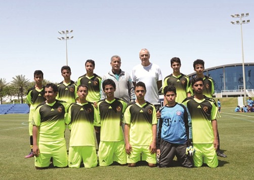 Qataru2019s national football team coach Jorge Fossati (back row, third from right) with players at the Aspire Football Festival for Preparatory Schools.