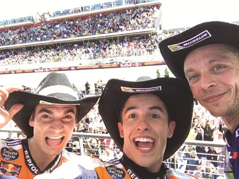 Grand Prix of the Americas winner Marc Marquez (centre) of Honda clicks a selfie with second-placed Valentino Rossi (right) of Yamaha and Honda teammate Dani Pedrosa on the podium at the Circuit of the Americas in Austin, Texas, yesterday. (Twitter/MotoGP)