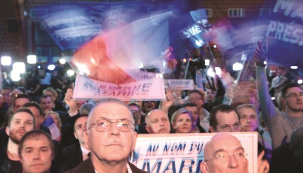 Le Pen supporters in Henin-Beaumont, northwestern France, appear subdued following the announcement of the results of the first round of the presidential election.