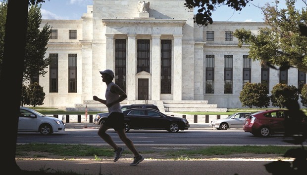 A runner passes the Federal Reserve building in Washington, DC. The Fed has hiked rates three times since December 2015, and longer-term bond yields have jumped since July of last year, which have made some investors more fearful about the potential for bond prices to drop further.