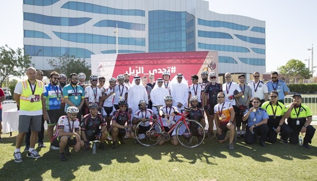 Qatar Rail officials with cyclists at the closing ceremony.